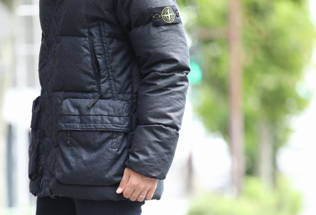ストーンアイランドのダウンジャケットを着用した男性