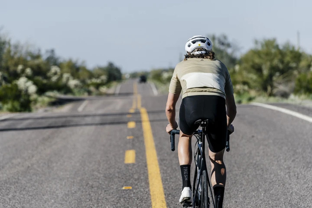 セブンメッシュのサイクルジャージを着て自転車に乗る男